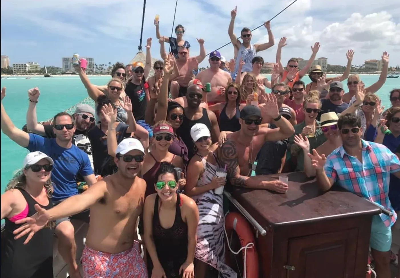 A big group of guests cheering aboard the schooner