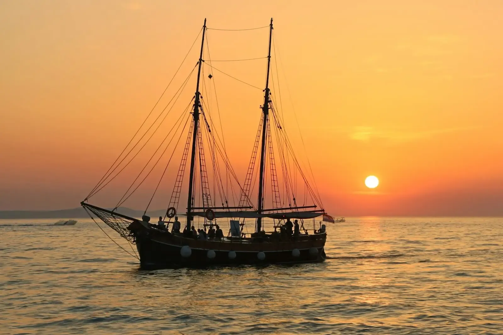 Flagship Aruba's schooner sailing into the sunset with guests aboard