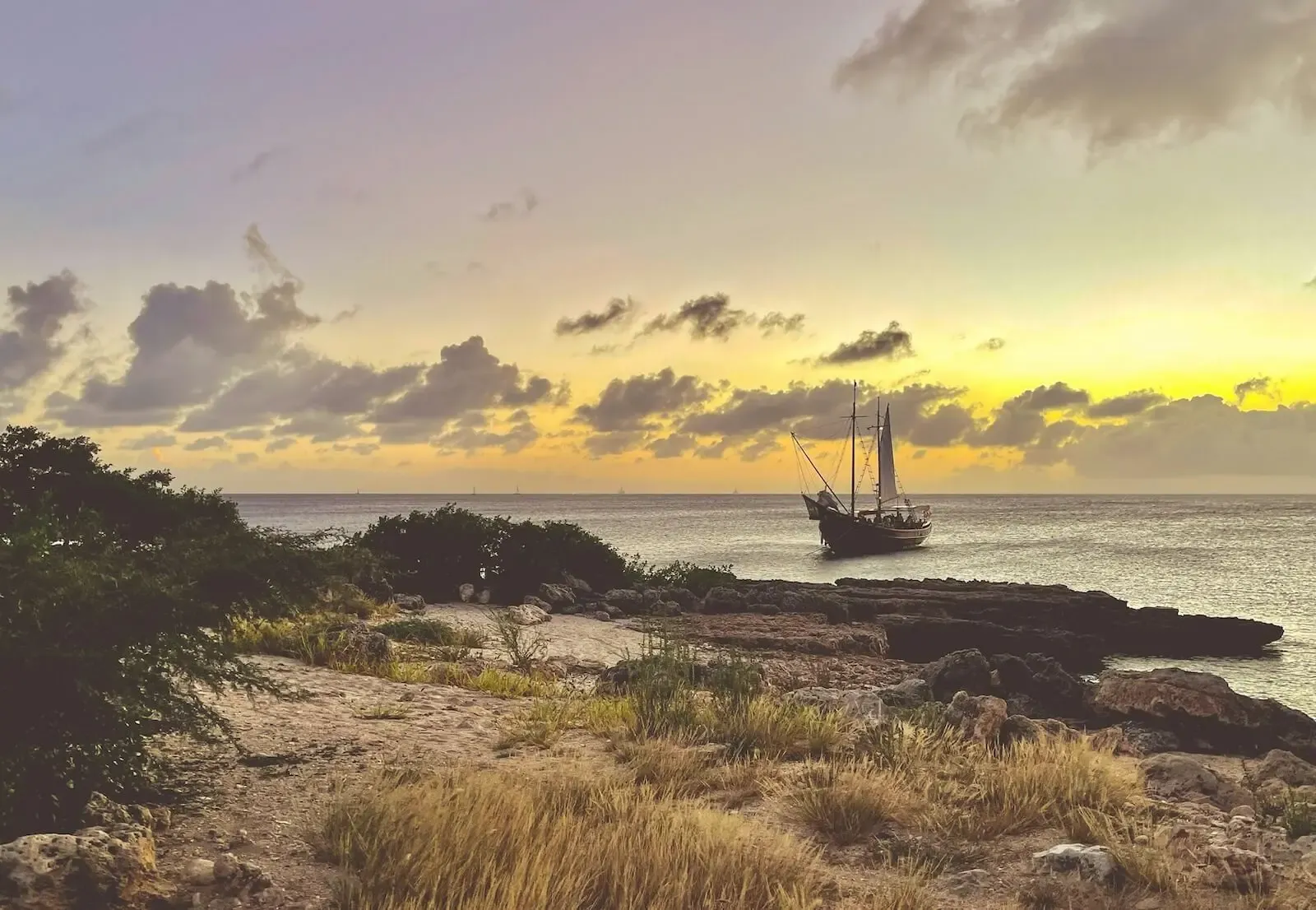 Flagship Aruba's schooner along the coastline in the early morning light