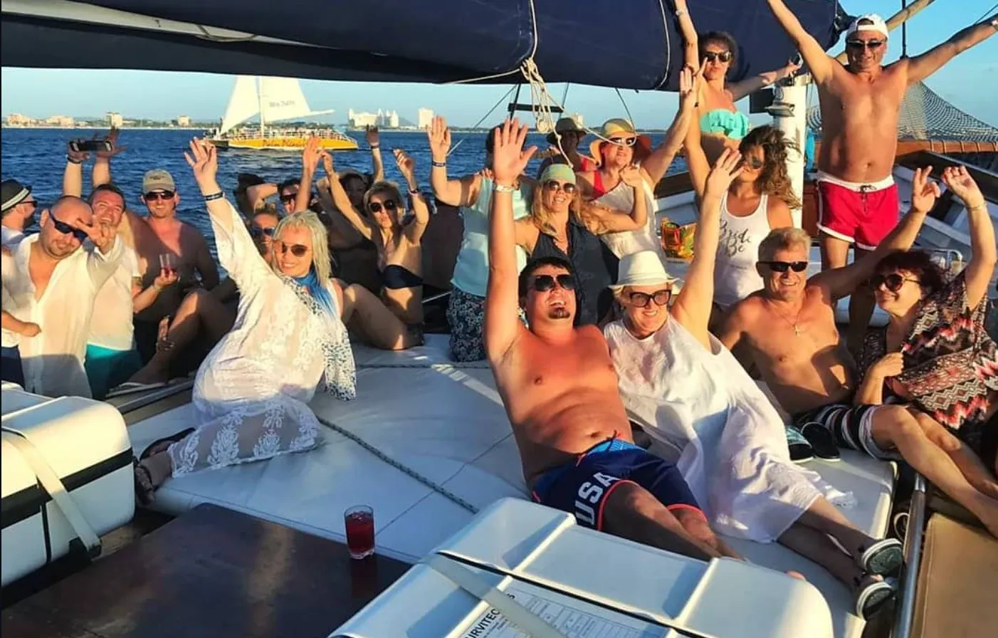 Guests celebrating together at sunset on the boat